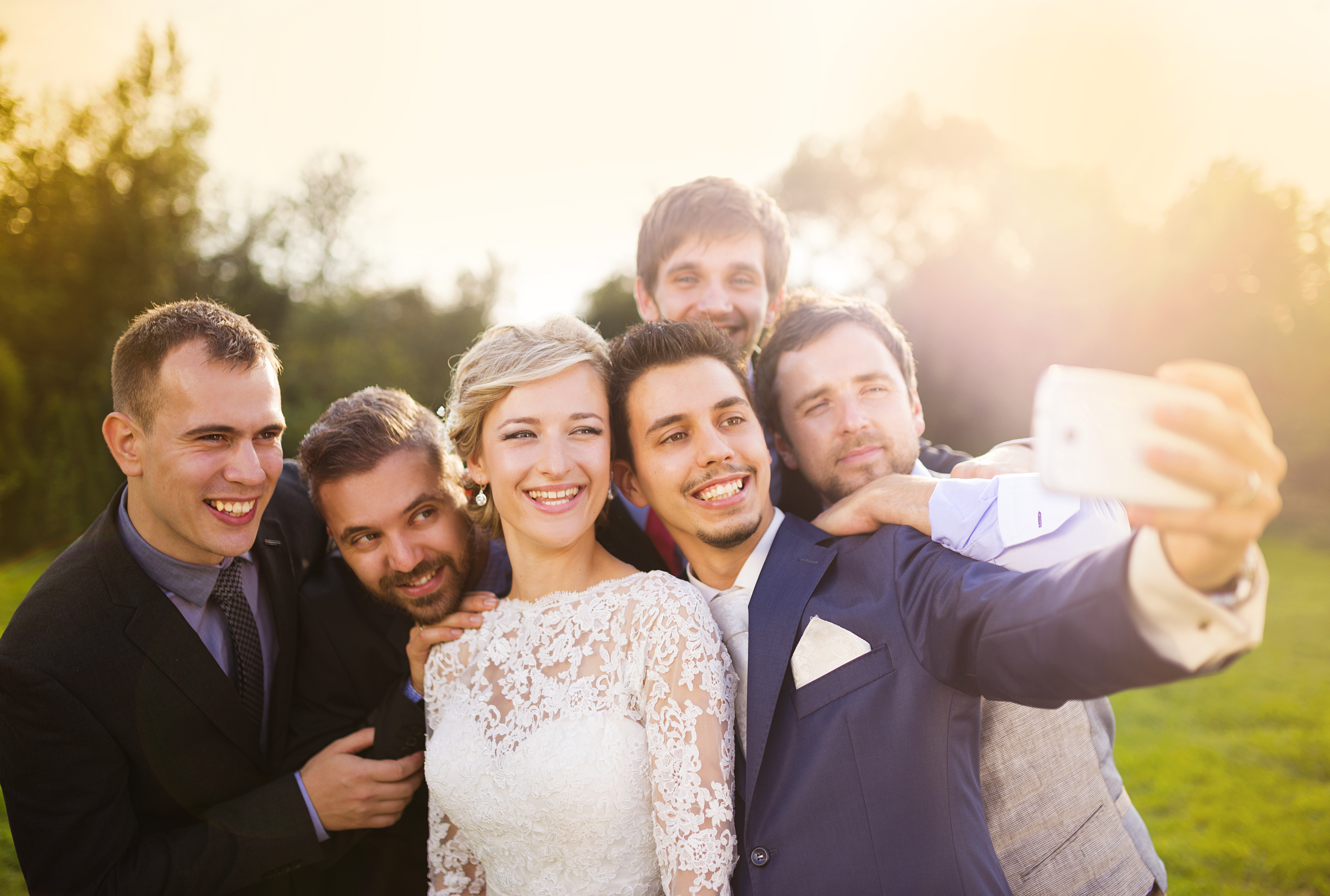 Wedding guests taking a selfie together, smiling and celebrating